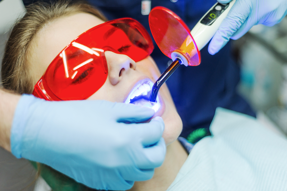 A dentist using a laser for a precise and painless dental procedure to treat gums or teeth